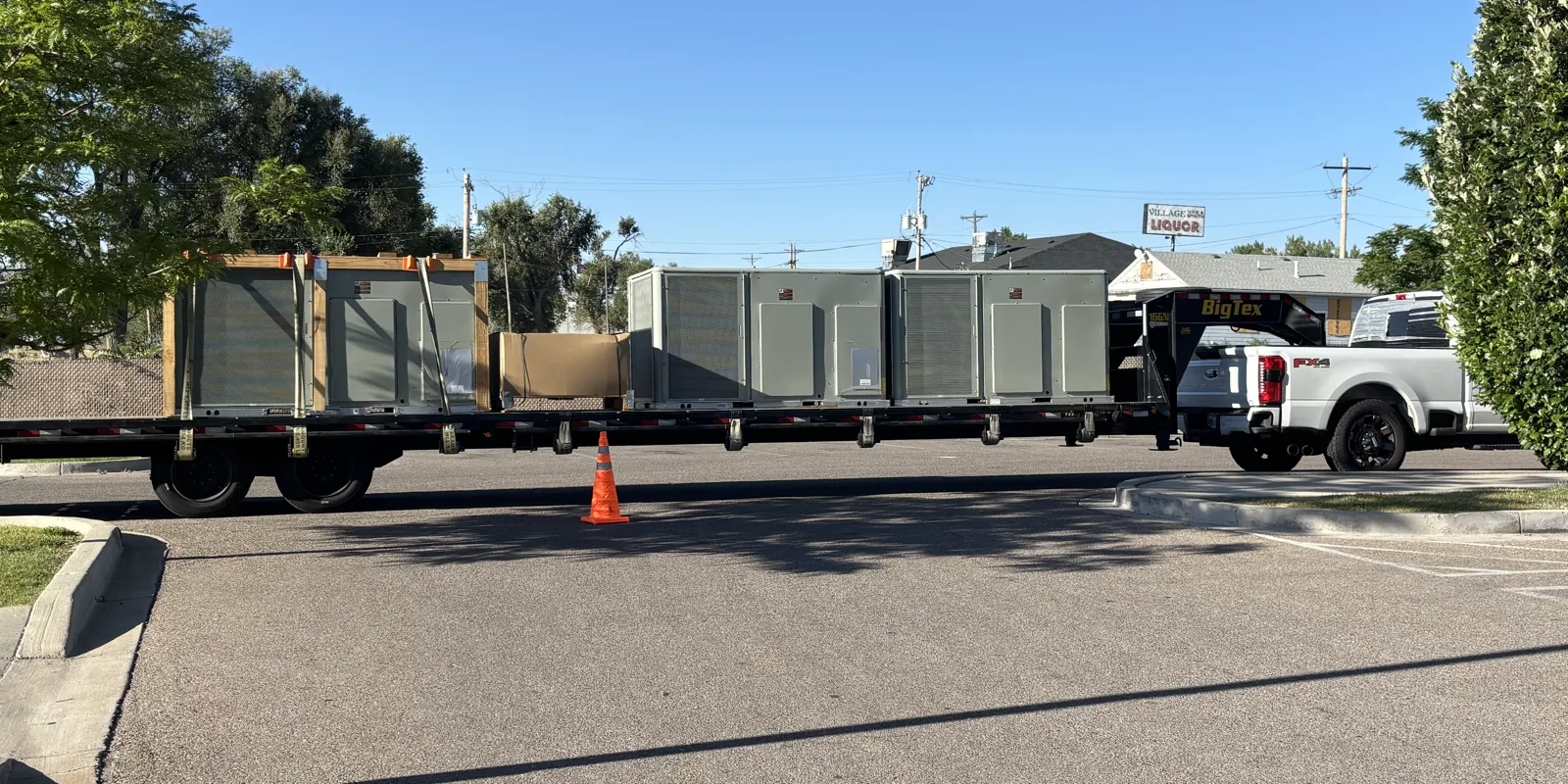 Accutemp delivering new commercial rooftop HVAC units on a flatbed truck in Northern Colorado
